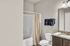 Elegant bathroom with granite countertop, modern fixtures, and plush navy towels, offering a serene escape.