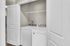 Modern laundry area in an apartment with energy-efficient washer and dryer, perfect for convenient living.