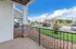 Charming patio view with elegant stone accents and lush greenery, offering a serene outdoor escape in a vibrant community setting.