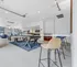 Chic communal lounge area with modern seating, game tables, and stylish decor perfect for social gatherings.