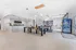Spacious community room with modern bar counter, stylish lighting fixtures, and multipurpose tables. Perfect for social gatherings and leisure activities.