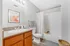 Bright and inviting bathroom boasting modern fixtures, elegant wooden cabinetry, and sleek contemporary decor.