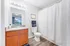 Bright and elegant bathroom with modern fixtures, featuring a spacious vanity, large mirror, and soft lighting for a relaxing atmosphere.