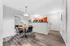 Inviting interior dining area with modern furniture, sleek flooring, and a stylish open kitchen with warm wooden cabinets.