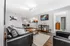 Contemporary open-concept living space with elegant decor, cozy seating, and a modern kitchen view, ideal for stylish urban living.