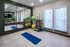 Modern fitness room with large mirrors, exercise balls, and a yoga mat, offering a bright and inspiring workout space.