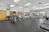 Modern, well-equipped gym with a variety of fitness machines, free weights, and ample space for workouts.