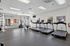 Bright and spacious gym with modern treadmills and versatile strength training equipment.