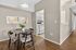 Cozy dining area with modern wooden furniture, stylish decor, and a glimpse of a functional kitchen, offering a warm and inviting atmosphere.
