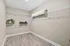 Spacious walk-in closet with elegant hardwood flooring and organized white shelving for ultimate storage.