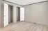 Spacious room with elegant wooden floors and two open closets, perfect for modern living.
