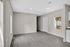 Bright and inviting empty room with sleek hardwood flooring, recessed lighting, and plenty of natural light from a window overlooking greenery.