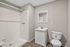 Bright modern bathroom featuring a pristine walk-in shower, sleek vanity, and elegant flooring.