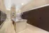 Modern apartment mailroom with sleek brown lockers and a polished stone countertop, offering a secure and stylish package retrieval experience.