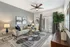 Elegant living room featuring a cozy gray sectional sofa, chic decor, abundant natural light, and stylish accents with a modern ceiling fan.