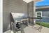 Functional outdoor utility area with sleek stainless steel fixtures, ideal for versatile usage and thoughtful apartment design.