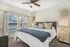 Cozy bedroom with a plush king-sized bed, elegant decor, and large windows inviting natural light.