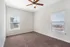 Bright and spacious bedroom with plush carpet and large windows offering natural light.