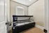 Bright and inviting apartment room featuring a sleek tanning bed, enhanced by natural light and elegant flooring.