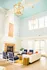 Bright and inviting living room with high ceilings, elegant pendant lights, and a chic fireplace, perfect for relaxation and entertaining.