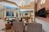 Elegant and spacious living area featuring modern decor, large windows, and a view of the pool, perfect for entertaining and relaxation.
