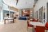 Luxurious modern lounge with high ceilings, elegant lighting, billiards table, and vibrant seating area.