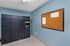 Modern package room featuring secure Luxer One lockers alongside a spacious bulletin board, ideal for convenient resident communication and package management.