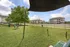 Inviting outdoor space with green lawn, modern play equipment, and scenic views of charming apartments.