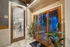 Inviting fitness center entry with sleek sauna, vibrant plants, and elegant decor, promising a luxurious wellness experience.