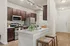 Modern kitchen with sleek granite countertops, stainless steel appliances, and stylish wooden cabinets, featuring a cozy breakfast bar with chic seating.