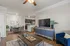 Bright, open-concept living area with elegant hardwood floors, modern dining set, and sleek kitchen in a stylish apartment.