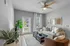 Inviting living room with stylish decor, featuring a plush sofa, modern coffee table, and abundant natural light from large windows.