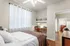 Bright, inviting bedroom with elegant decor, cozy bed, and functional workspace perfect for productivity.
