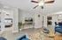 Modern apartment living room with elegant decor, featuring a cozy bedroom view, contemporary ceiling fans, and an inviting open-plan kitchen, perfect for stylish urban living.