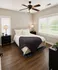 Cozy bedroom with elegant decor, featuring a comfortable bed, stylish nightstands, and large windows for natural light.