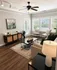 Modern living room with elegant decor, featuring a plush sofa, stylish coffee table, and large windows for abundant natural light.