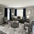 Inviting living room with contemporary furniture, plush seating, and elegant decor, bathed in natural light for a warm, cozy ambiance.