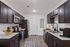 Modern kitchen with sleek dark cabinets, stainless steel appliances, and elegant granite countertops, offering a stylish and functional cooking space.