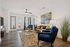 Bright and inviting living room with stylish furniture, modern decor, and natural light streaming through large windows.