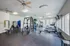 Spacious and modern fitness center equipped with cardio machines, weight stations, and bright natural lighting.