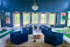 Luxurious lounge area with elegant navy seating and indoor bowling alley, highlighted by natural light and tasteful decor.