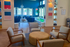 Chic modern lounge area with elegant seating, vibrant wall art, and large windows for natural light.