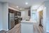 Modern kitchen with sleek granite countertops, stainless steel appliances, and abundant cabinetry, perfect for culinary enthusiasts.