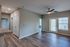 Inviting apartment featuring sleek modern flooring, bright open spaces, and stylish ceiling fan, perfect for comfortable living.