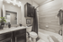 Elegant bathroom featuring a sleek granite countertop, modern fixtures, and stylish tilework in a cozy apartment.