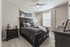 Elegant bedroom with a luxurious dark wood bed set, cozy bedding, and modern decor, enhanced by soft natural light.