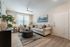 Inviting living room with elegant couches, lush plants, and soft lighting, offering a cozy and stylish ambiance.