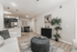Contemporary living room with an open layout, elegant decor, and a stylish kitchen view.