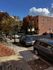 Charming street view with vibrant autumn trees and cozy brick buildings, perfect for urban living.