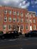 Charming red brick townhouse with classic architecture and abundant natural light, perfect for urban living.
